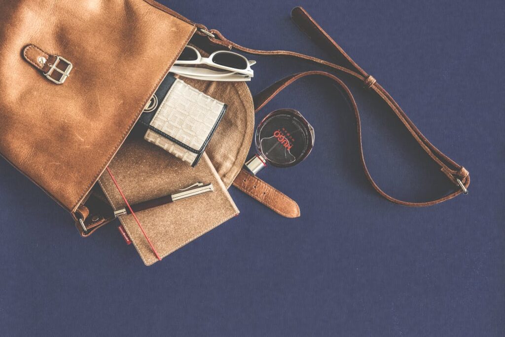 Brown leather crossbody luxury bag with accessories — Hermès style